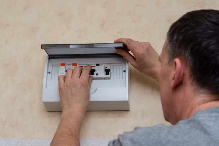 Picture of a guy turning off the switch of main electrical box