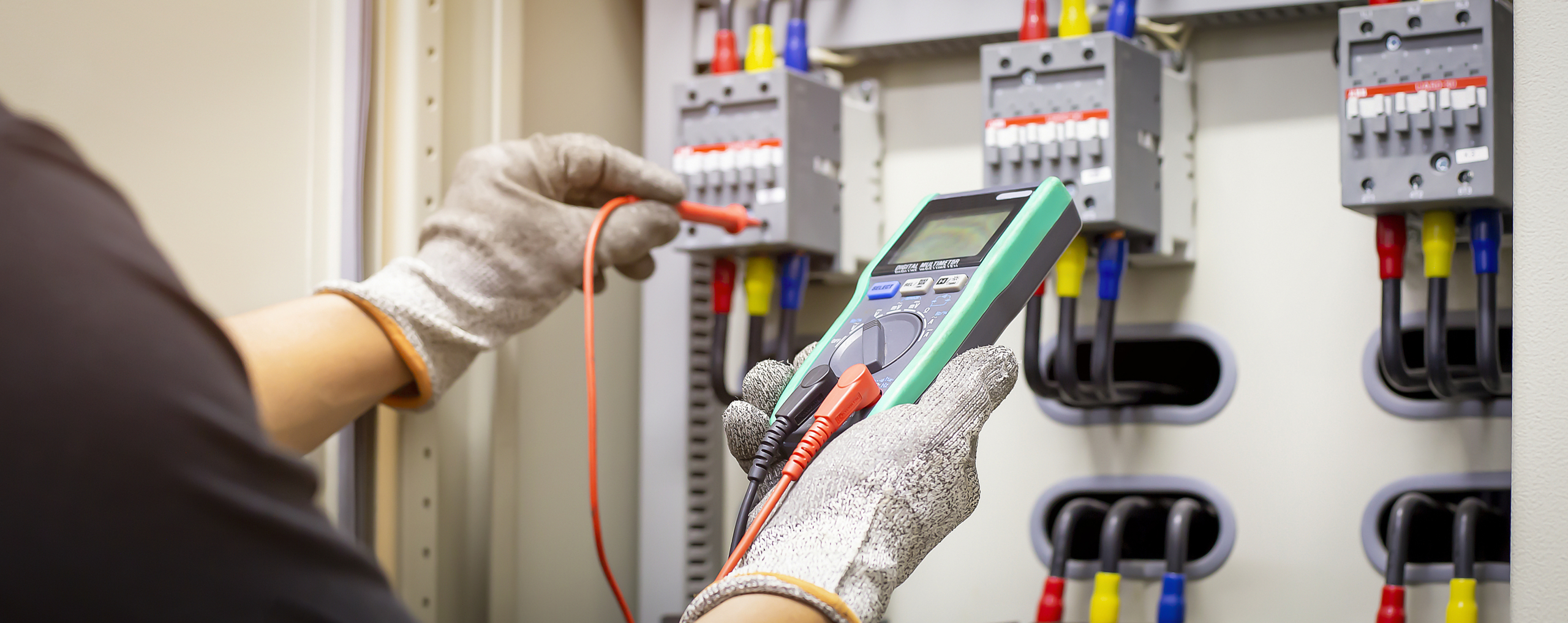 An electrical professional testing flow of current with the help of voltage tester