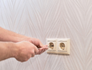 A guy Installing sockets on wall