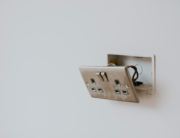 Picture of an electrical board hanging from the fixture in wall